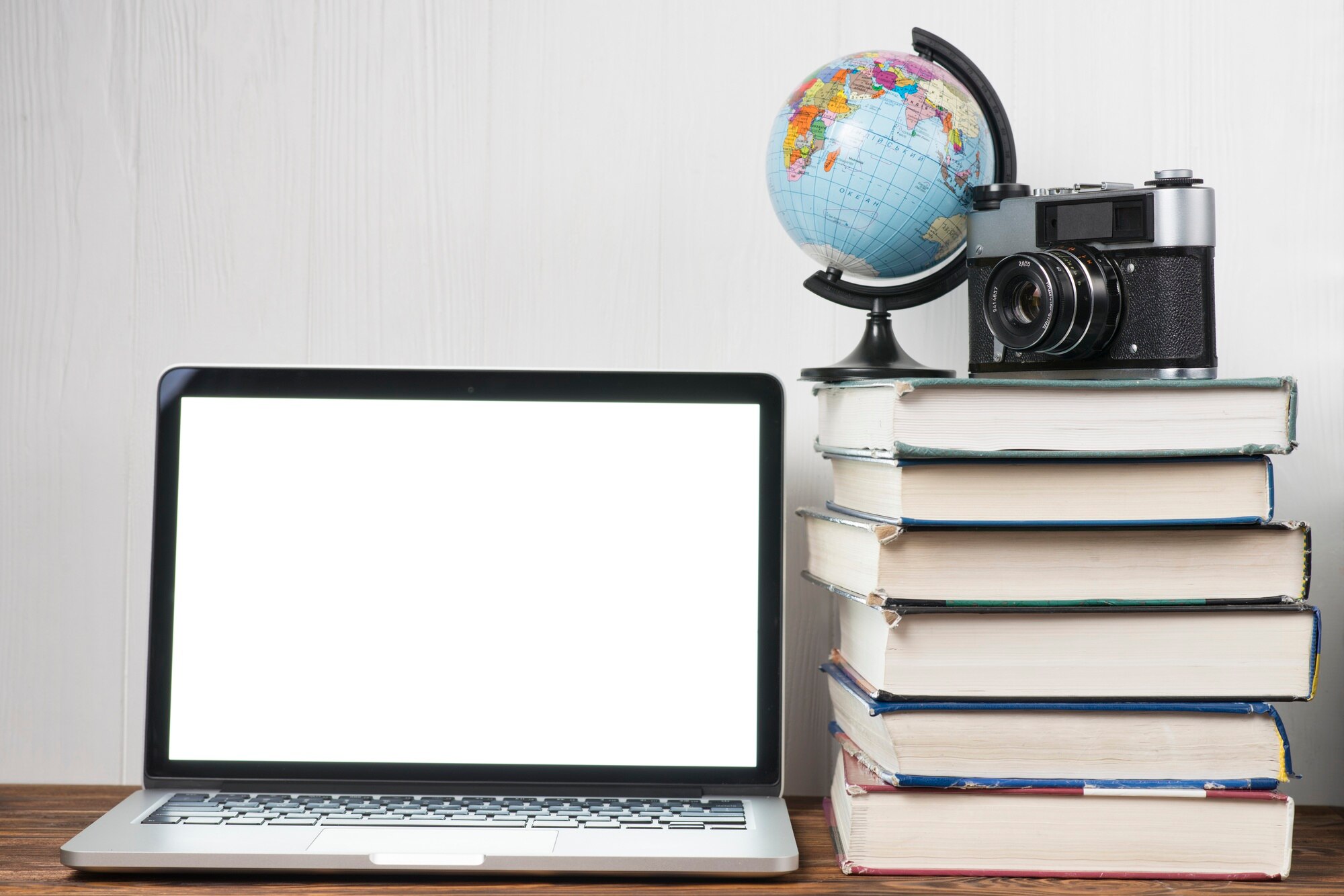 globe-camera-books-near-laptop_23-2147772309